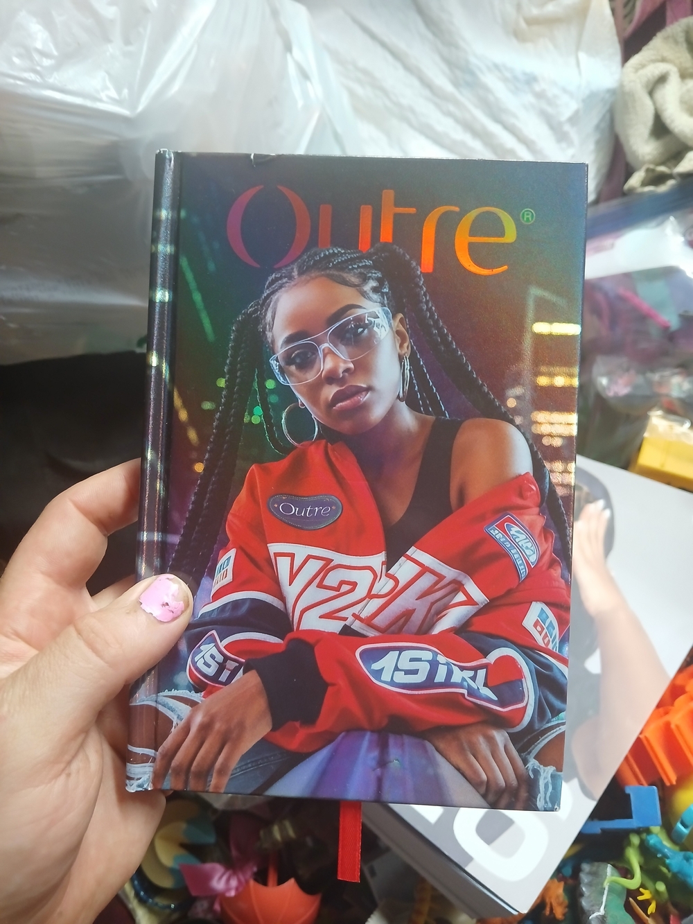 an Outre hair product Lookbook  featuring a Y2K-inspired cover design 2026